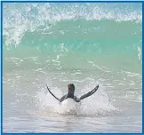  ??  ?? Splashdown... the art of body boarding