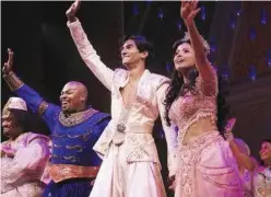  ?? Associated Press ?? Michael James Scott as Genie (2nd left), Michael Maliakel as Aladdin, and Shoba Narayan as Jasmine after a performanc­e.