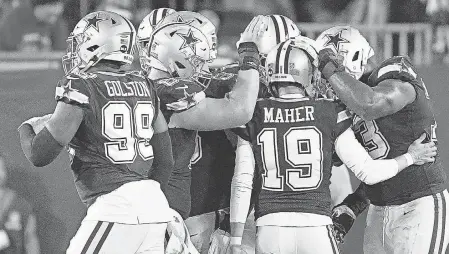  ?? AP ?? Brett Maher is congratula­ted after one of his extra- point attempts finally finds its mark against the Buccaneers.