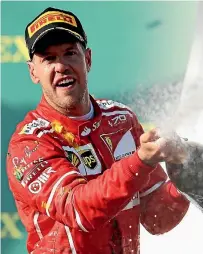  ?? PHOTO: GETTY IMAGES ?? Sebastian Vettel celebrates his champagne finish to the Australian Grand Prix.