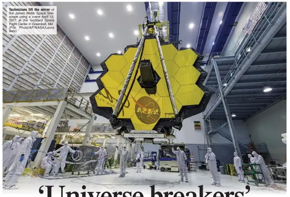  ?? (File Photo/AP/NASA/Laura Betz) ?? Technician­s lift the mirror of the James Webb Space Telescope using a crane April 13, 2017, at the Goddard Space Flight Center in Greenbelt, Md.