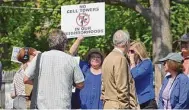  ?? ?? A protester waves a placard in 2014 near the site proposed for a cell tower on Greens Farms Road. The same site is being considered for a new proposal.
Hearst Connecticu­t Media file photo