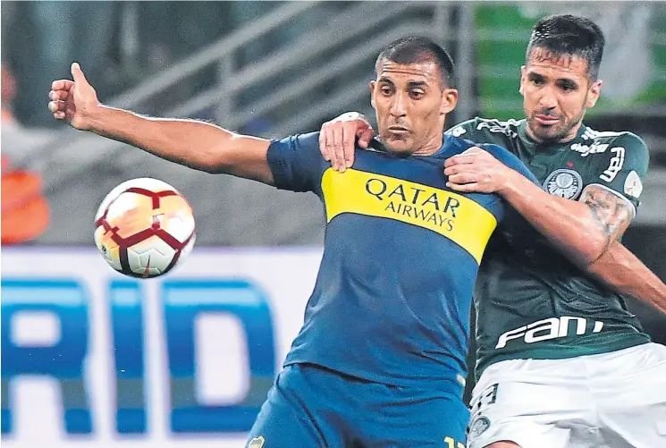  ??  ?? Ábila, autor del primer gol, aguanta la marcación de luan; Wanchope volvió a ser importante para desgastar a los zagueros de palmeiras