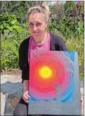  ?? COURTESY OF SOUND COMMUNITY SERVICES ?? Heather Lindell, 35, with a painting she was given by a Sound Community Services case manager for her new apartment on Hamilton Avenue in Norwich.