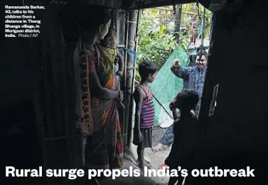  ?? Photo / AP ?? Ramananda Sarkar, 43, talks to his children from a distance in Theng Bhanga village, in Morigaon district, India.