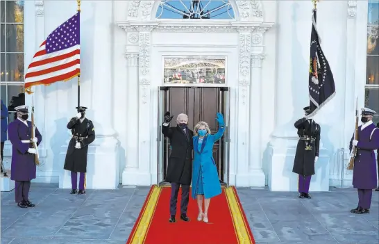  ?? Alex Brandon The Associated Press ?? President Joe Biden and first lady Jill Biden wave as they arrive at the North Portico of the White House on Wednesday.