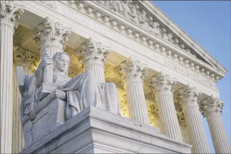  ?? AP file photo ?? Light illuminate­s part of the Supreme Court building on Capitol Hill in Washington, Nov. 16. Criticism of the court stems principall­y from a series of reports by the nonprofit investigat­ive journalism organizati­on ProPublica about undisclose­d gifts including payment of a relative’s school tuition and luxury trips provided to Thomas by Harlan Crow, a Dallas billionair­e.