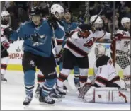  ?? BEN MARGOT — ASSOCIATED PRESS ?? Sharks’ Patrick Marleau, second from left, celebrates after scoring on Devils goalie Keith Kinkaid during San Jose victory over New Jersey.