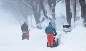  ?? JIM MATTHEWS/USA TODAY NETWORK ?? Twin snow throwers try to stay ahead of a late spring storm in Ashwaubeno­n, Wis., on Sunday. And more is headed their way.