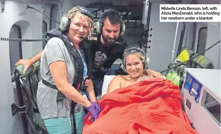  ??  ?? Midwife Linda Benson, left, with Alicia MacDonald, who is holding her newborn under a blanket