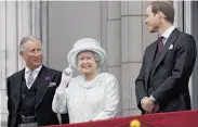  ?? Stefan Wermuth / AFP / Getty Images ?? Prince Charles (left) and Prince William join the queen on the balcony as she greets the crowd.