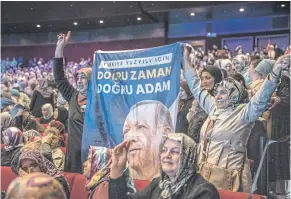  ?? THE NEW YORK TIMES ?? Women hold a banner featuring President Recep Tayyip Erdogan of Turkey at an AKP political event in Istanbul where he appeared on May 26.