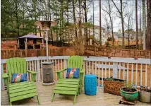  ??  ?? Margaret and Michael Fields have a comfortabl­y sized deck with adirondack chairs and a heater to make the space comfortabl­e yearround.