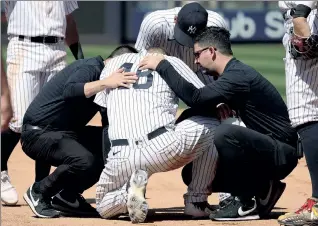  ?? Robert Sabo ?? OUCH: Yankees first baseman Anthony Rizzo receives attention from the training staff after a collision with Fernando Tatis Jr. in the sixth inning of Sunday’s win.