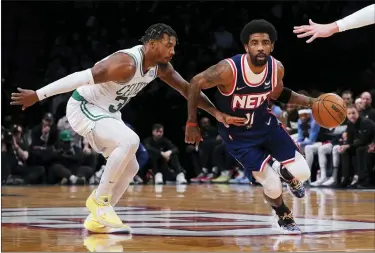  ?? THE ASSOCIATED PRESS FILE ?? Nets guard Kyrie Irving (11) drives past Celtics guard Marcus Smart, left, during the first half of Game 4of a first-round playoff series.