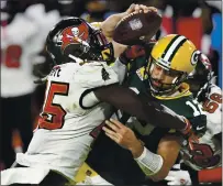  ?? JASON BEHNKEN — THE ASSOCIATED PRESS ?? Tampa Bay’s Devin White (45) sacks Packers quarterbac­k Aaron Rodgers during Sunday’s game. The Bucs face the Raiders next.