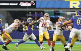  ?? HARRY HOW GETTY IMAGES ?? Niners QB Jimmy Garoppolo throws it before Rams’ Von Miller gets to him.