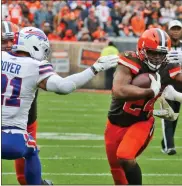  ?? AP-Ron Schwane ?? Browns running back Nick Chubb (24) rushes between Bills free safety Jordan Poyer (21) during the first half of an NFL football game Nov. 10 in Cleveland.