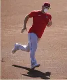  ?? The Associated Press ?? Angels center fielder Mike Trout runs the bases during practice at Angels Stadium on Friday.