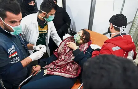  ??  ?? Terrifying ordeal: A woman receiving treatment for gas inhalation at a hospital in regime-controlled Aleppo. — AFP