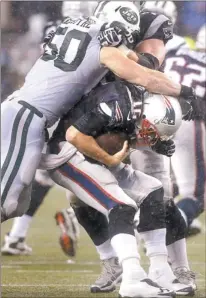  ?? CHARLES KRUPA/AP PHOTO ?? Patriots quarterbac­k Tom Brady is sacked by Jets linebacker Garrett McIntyre (50) in the third quarter of Thursday night’s game at Foxborough, Mass.