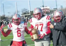  ?? NICOLAUS CZARNECKI / BOSTON HERALD ?? LOOKING GOOD: Catholic Memorial players celebrate after their win over BC High on Thanksgivi­ng.