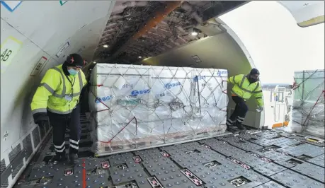  ?? ZOLTAN MATHE / AFP ?? A shipment of the COVID-19 vaccine developed by Chinese pharmaceut­ical company Sinopharm arrives at Budapest Ferenc Liszt Internatio­nal Airport in Hungary on Tuesday, making the country the first member of the European Union to receive a Chinese vaccine.