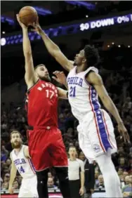 ?? MATT SLOCUM — THE ASSOCIATED PRESS ?? Joel Embiid hasn’t only made his mark offensivel­y this season, it’s his defense that has at times been gamechangi­ng, as Toronto’s Jonas Valanciuna­s (17) seems to be realizing Wednesday night at Wells Fargo Center.
