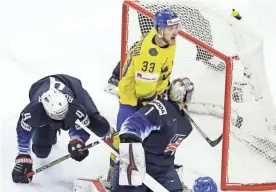  ??  ?? Sweden’s Viktor Arvidsson, top, reacts after scoring the opening goal against the United States on Saturday in Copenhagen, Denmark. PETR DAVID JOSEK/AP