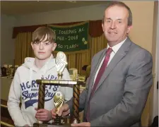  ??  ?? Evan O’Toole, junior male athlete of the year and Pat Power, club chairman at the St Joseph’s Athletic Club 50th anniversar­y dinner dance in the Rhu Glen.