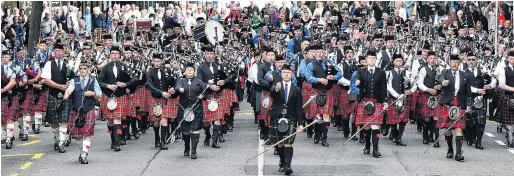  ?? PHOTOS: PETER MCINTOSH ?? Stirring the blood . . . Andrew McLellan (centre) leads a mass parade of pipe bands north along George St from the Octagon at 4.30pm on Saturday.