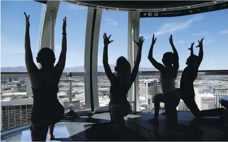  ??  ?? People take part in a yoga class at the High Roller observatio­n wheel in Las Vegas, one of many city venues given over to the pursuit of mindful fitness in a city known more for gambling.