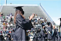  ?? (Pine Bluff Commercial/I.C. Murrell) ?? UAPB graduates give bestsellin­g author and political commentato­r Michael Eric Dyson a standing ovation after his commenceme­nt address Saturday.