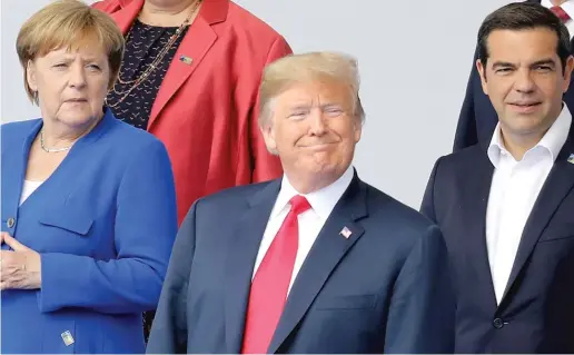  ?? LUDOVIC MARIN, VIA AP ?? German Chancellor Angela Merkel, President Donald Trump and Greek Prime Minister Alexis Tsipras pose for a photo on Wednesday ahead of the opening of the NATO summit in Brussels.