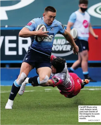  ?? GARETH EVERETT ?? Cardiff Blues wing Josh Adams races past Ioan Davies of the Dragons to score a try earlier this month.