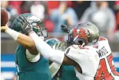  ?? AP ?? Former Buccaneers inside linebacker Devin White runs into Eagles quarterbac­k Jalen Hurts during a 2022 wild-card game in Tampa, Florida.