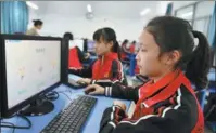  ?? WANG HUIFU / FOR CHINA DAILY ?? Students pay respect to the deceased through a website at their school in Zigui, Hubei province, in April last year.