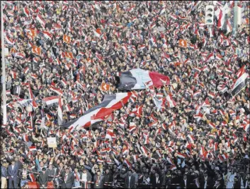  ?? KARIM KADIM/THE ASSOCIATED PRESS ?? Followers of Iraq’s Shiite cleric Muqtada al-Sadr chant slogans Saturday as they wave national flags during a demonstrat­ion in Baghdad against corruption. The protest turned violent and five were killed.