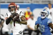  ?? PAUL SANCYA / ASSOCIATED PRESS ?? Cincinnati Bengals wide receiver Ja’marr Chase makes a reception as Detroit Lions cornerback Jerry Jacobs gives chase during the second half Sunday at Ford Field in Detroit.