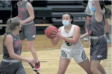  ?? Helen H. Richardson, The Denver Post ?? D’Evelyn Jaguars junior Chloe Klataske looks for someone to pass the ball to during the girls varsity basketball game on Monday night. D'Evelyn beat Heritage 44-11.