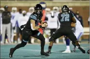  ?? RICHARD SHIRO — THE ASSOCIATED PRESS ?? Coastal Carolina quarterbac­k Grayson McCall, left, scrambles during the first half of an NCAA college football game against BYU, Saturday, Dec. 5, 2020, in Conway, S.C.