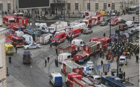  ?? (Reuters) ?? EMERGENCY VEHICLES assemble outside the Tekhnologi­cheskiy Institut metro station in St. Petersburg yesterday following the explosion.