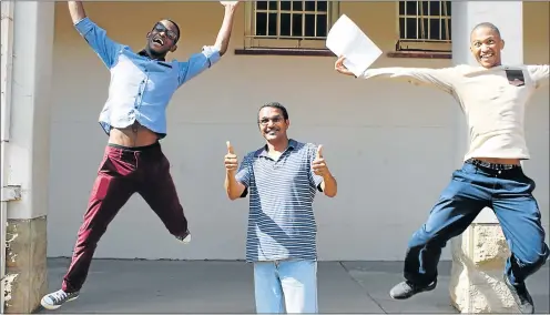  ?? Picture: ABONGILE SOLUNDWANA ?? JUMPING FOR JOY: Hexagon High School pupils, from left, Tebogo Klaas and Zikho Klaas (they are not related), celebrate as principal Malcolm Lentoor revels in a 97.58% pass rate at the Queenstown school