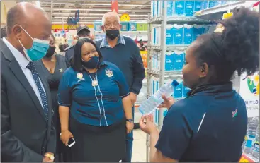  ?? Photo: Shoki Kandjimi ?? Local is lekker… Vice President Nangolo Mbumba alongside trade minister Lucia Iipumbu being shown some Namibian products on Shoprite’s shelves by Patricia Hangula.