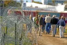  ?? AP PHOTO/ERIC GAY ?? Concertina wire lines the path as members of Congress tour an area near the Texas-Mexico border Jan. 3 in Eagle Pass, Texas.