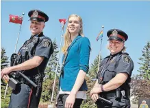  ?? LISA RUTLEDGE METROLAND ?? Const. Stephen Churm, left, Mara Haasnoot and Sgt. Julie Sudds of the Waterloo Regional Police share messages of inclusion and acceptance.