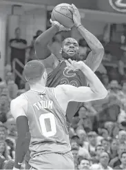  ?? Gregory Shamus / Getty Images ?? LeBron James rises to the occasion against the Celtics’ Jayson Tatum on Monday night.