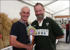  ??  ?? Jimmy Nolan presenting Servaas Dodebier with the Lar Shiggins Memorial Cup for best overall in the agricultur­e section