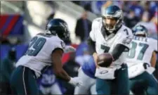  ?? JULIO CORTEZ — THE ASSOCIATED PRESS ?? A simple handoff from Sam Bradford, right, to DeMarco Murray turned into a 54-yard touchdown run in the first quarter of the Eagles’ 35-30victory Sunday when Jason Peters and his offensive linemates caved in the right side of the Giants’ front. Peters...