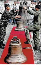  ?? BULLIT MARQUEZ/AP ?? Philippine personnel unload three church bells Tuesday seized as war trophies by U.S. troops in 1901.